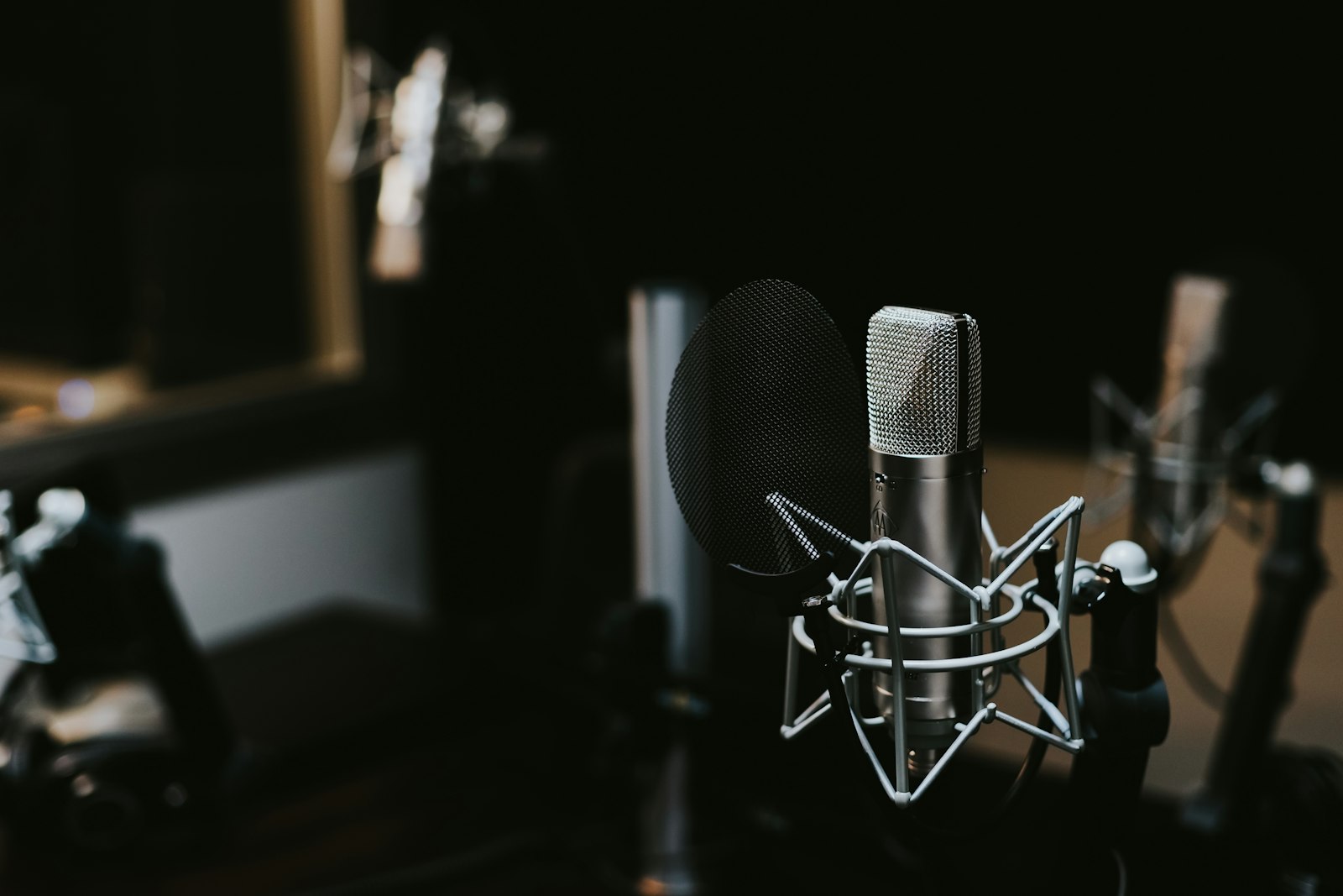 A studio microphone in soft light, ready to record a script.